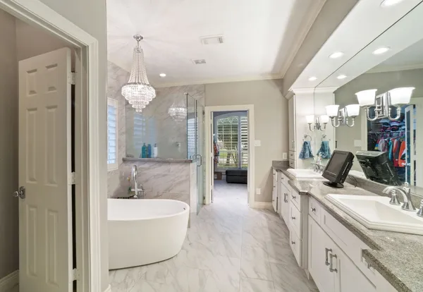 a bathroom with a granite countertop sink mirror and bathtub