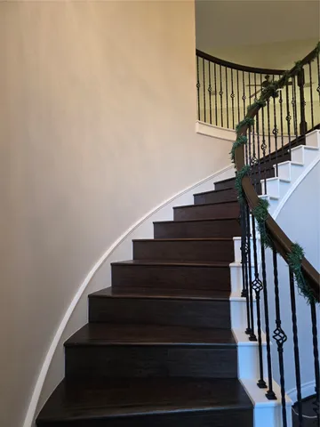 a view of a room with wooden floor and chandelier