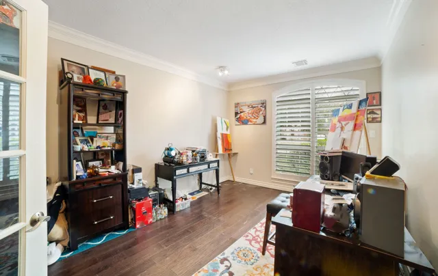 a large white kitchen with a large island oven a stove and a wooden floors