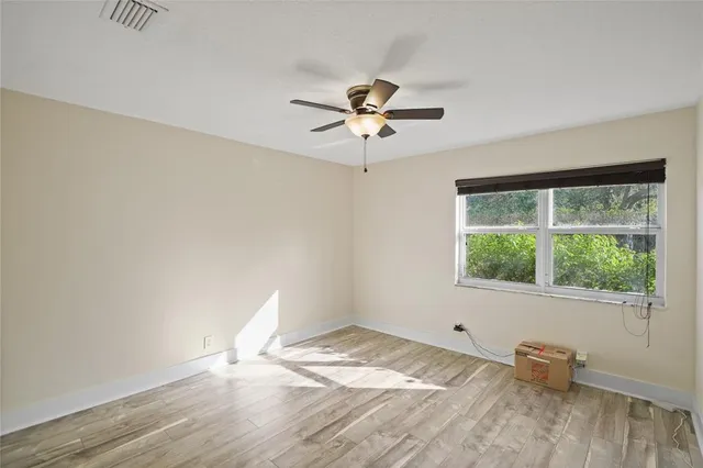 a view of a room with a ceiling fan
