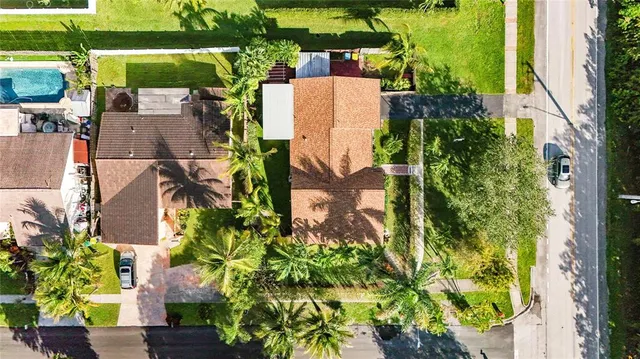 an aerial view of a house with a yard and garden