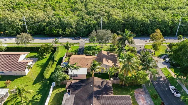 an aerial view of a house with a yard basket ball court and outdoor seating