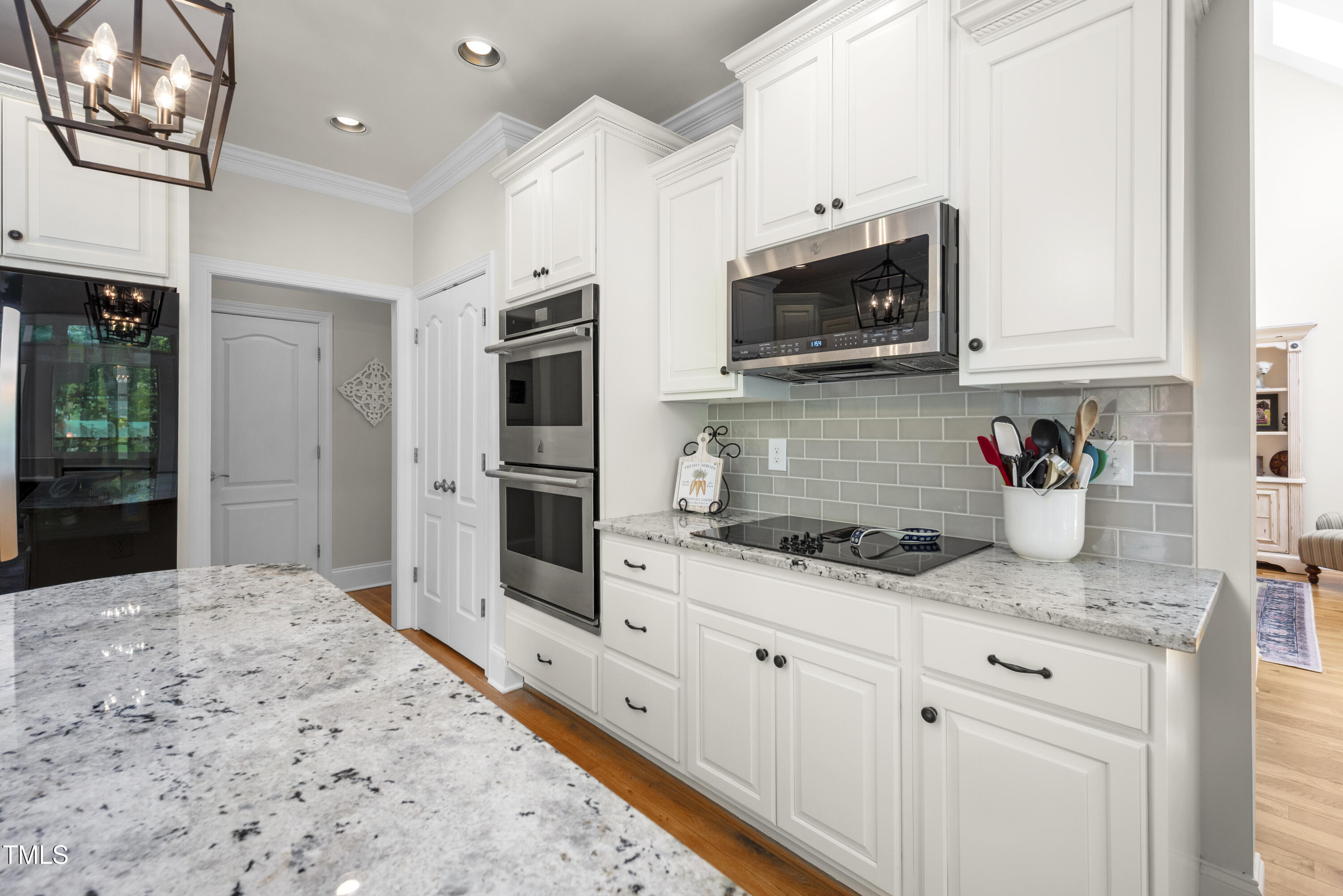 8480 Falkirk Ridge Court Wake Forest, NC 27587 - Photo 22 of 63 a kitchen with stainless steel appliances granite countertop a sink a stove and a refrigerator