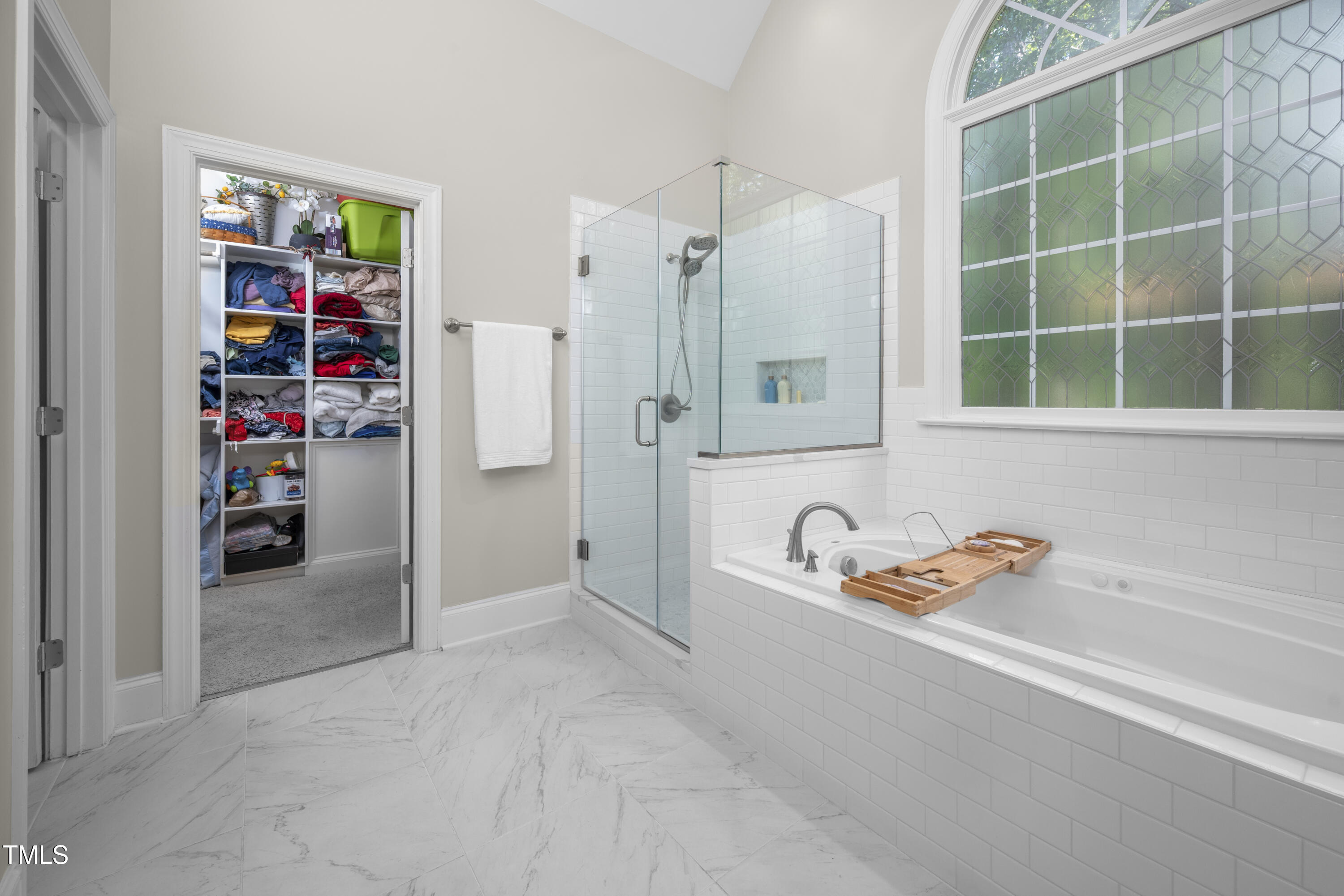 8480 Falkirk Ridge Court Wake Forest, NC 27587 - Photo 33 of 63 a bathroom with a tub and a shower