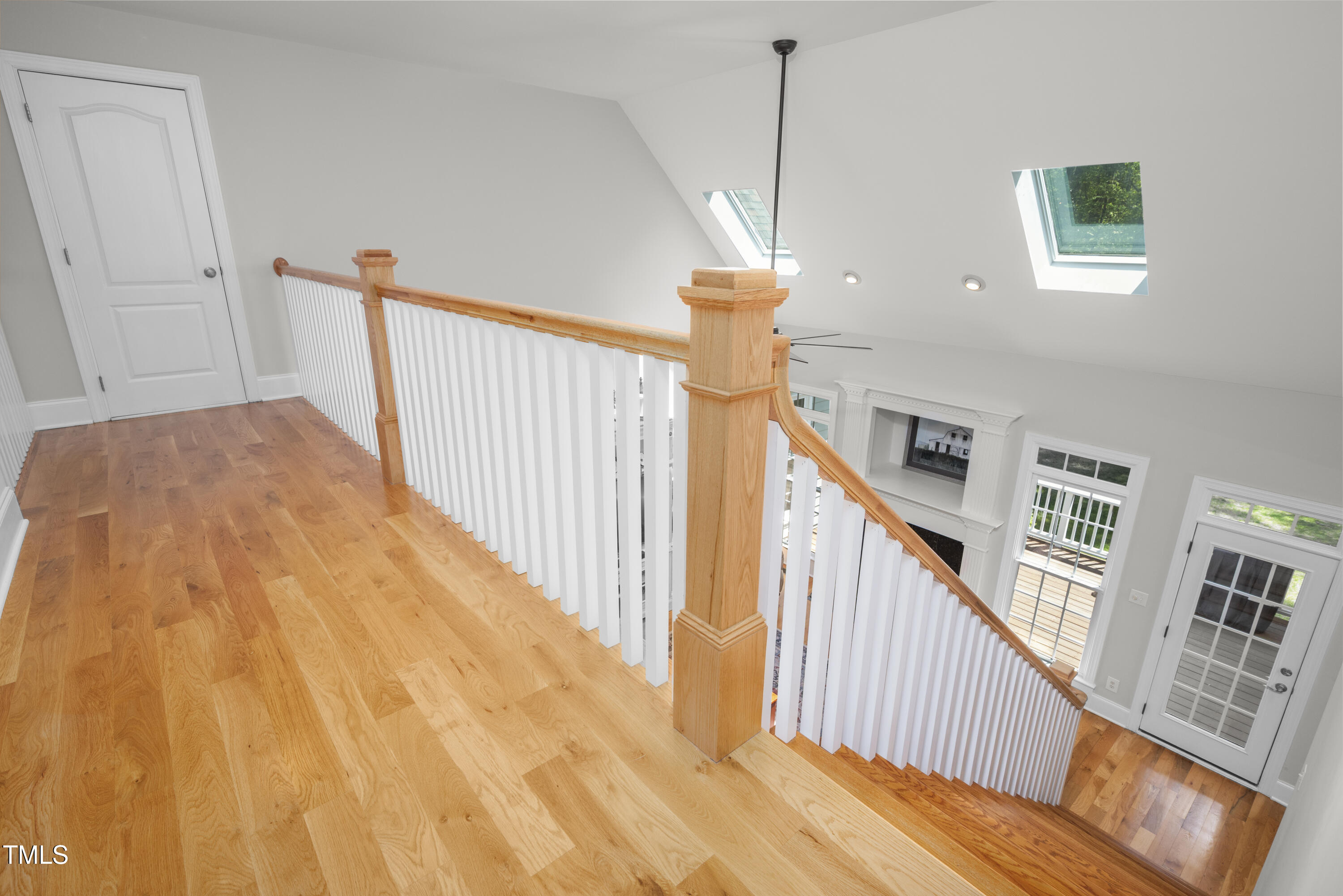 8480 Falkirk Ridge Court Wake Forest, NC 27587 - Photo 41 of 63 a view of staircase with lots of frames on wall and wooden floor