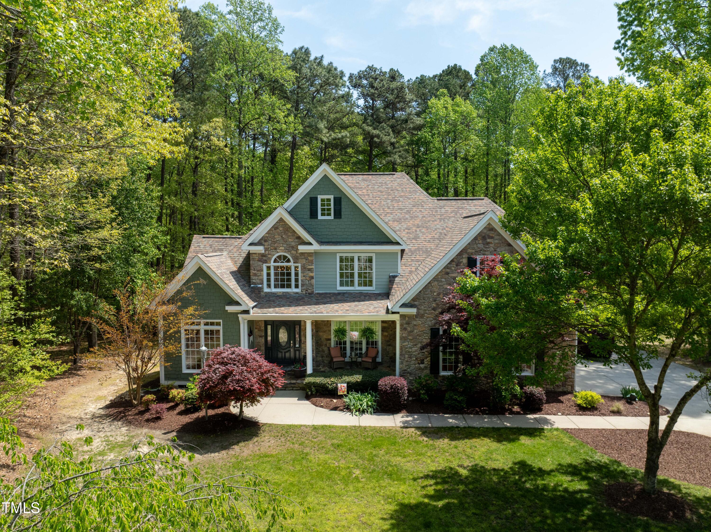 8480 Falkirk Ridge Court Wake Forest, NC 27587 - Photo 60 of 63 a front view of a house with garden and trees