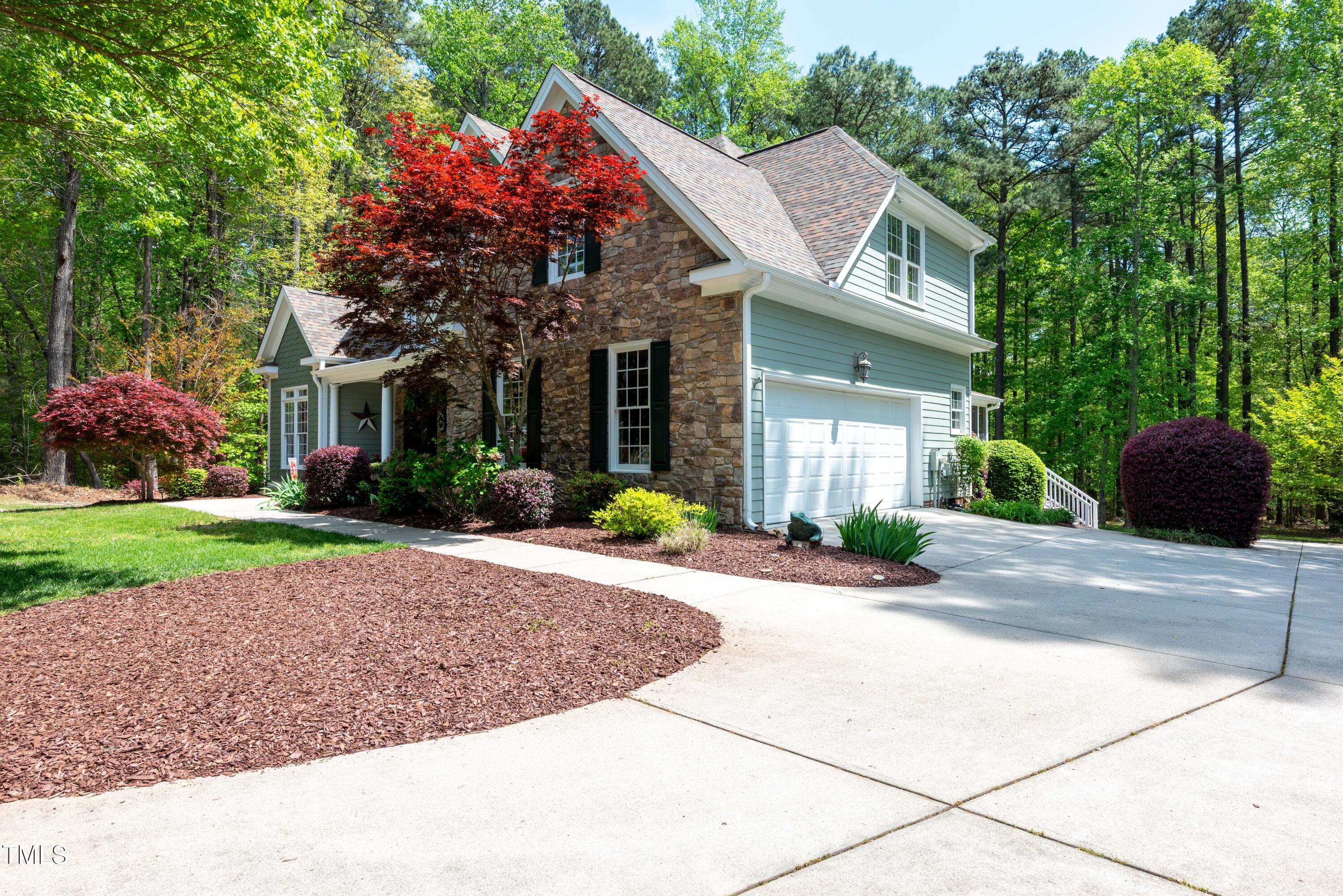 8480 Falkirk Ridge Court Wake Forest, NC 27587 - Photo 61 of 63 a front view of a house with a yard and potted plants