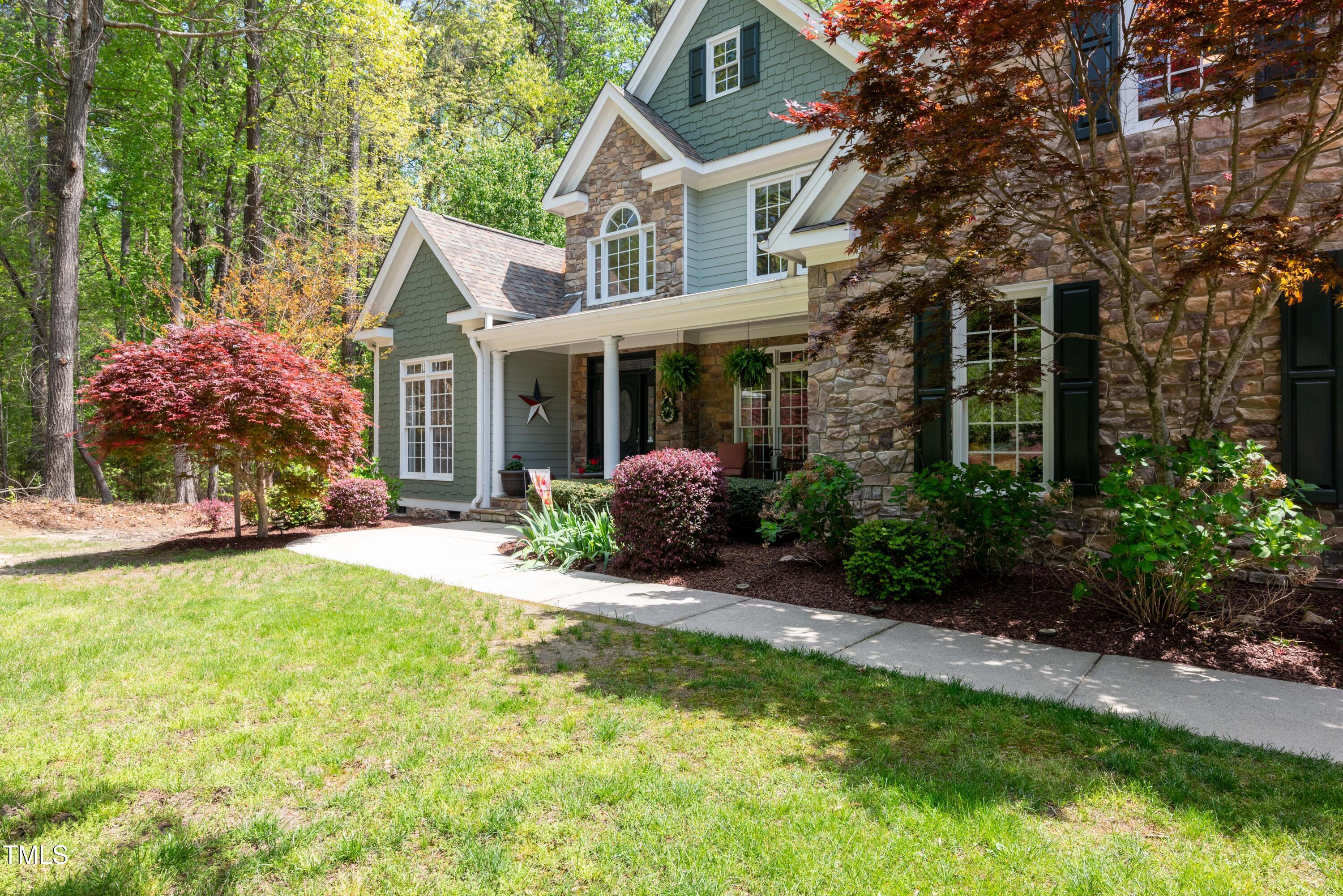 8480 Falkirk Ridge Court Wake Forest, NC 27587 - Photo 8 of 63 a front view of a house with garden