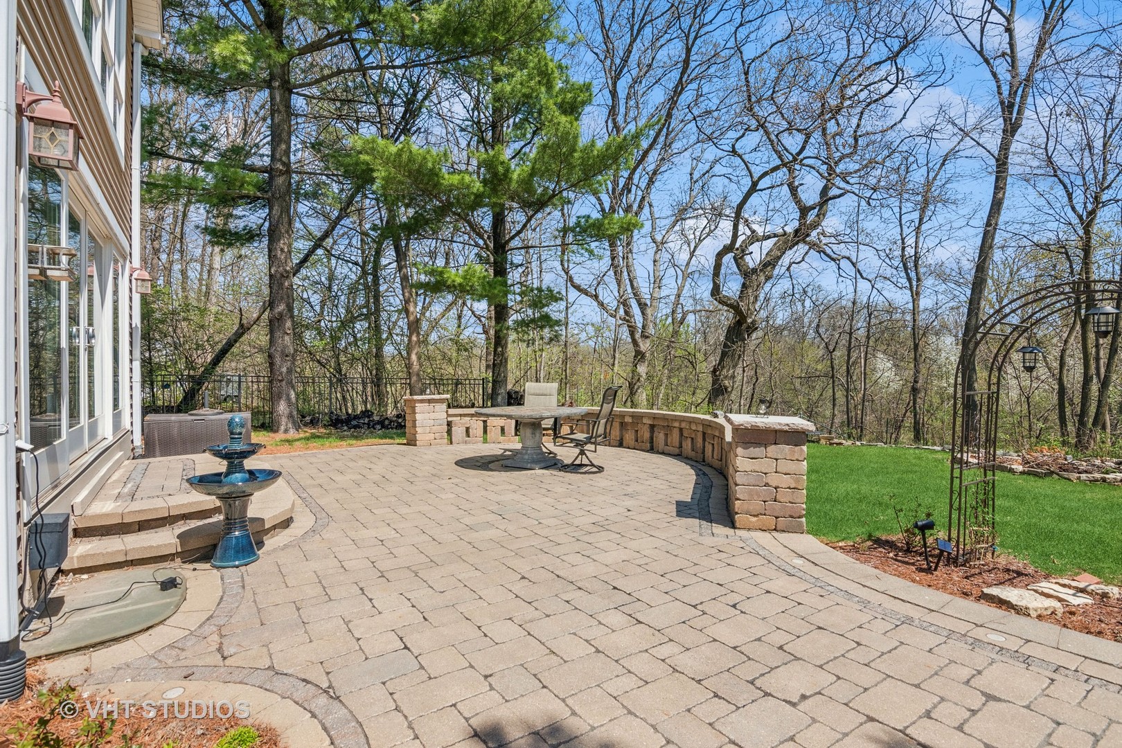 59 2s283 Route Warrenville, IL 60555 - Photo 13 of 49 a view of a backyard with table and chairs and a fire pit