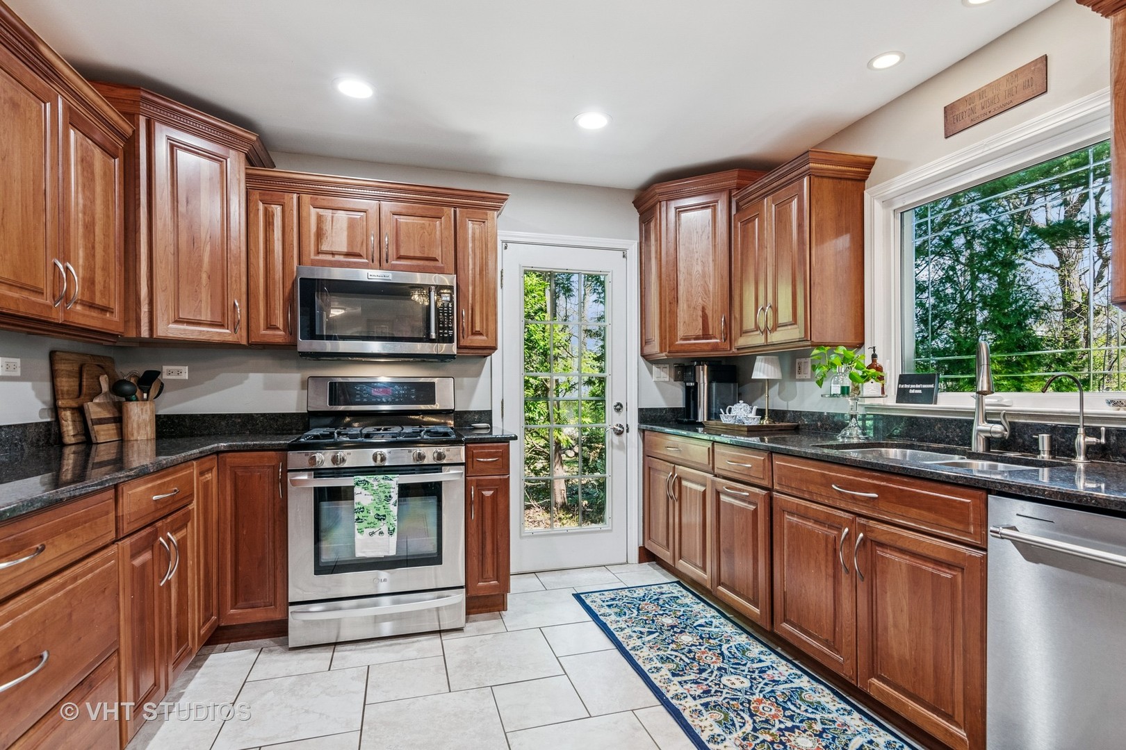 59 2s283 Route Warrenville, IL 60555 - Photo 23 of 49 a kitchen with stainless steel appliances granite countertop a stove top oven a sink dishwasher and wooden cabinets with wooden floor