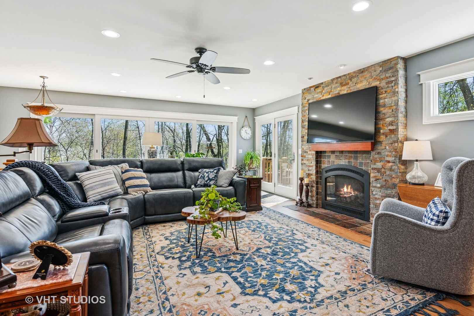 59 2s283 Route Warrenville, IL 60555 - Photo 26 of 49 a living room with furniture a fireplace and a flat screen tv
