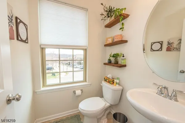 a bathroom with a sink mirror and toilet