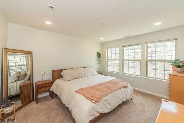 a bedroom with a large bed and a large window