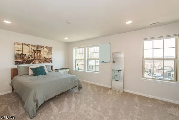 a bedroom with a large bed and a window
