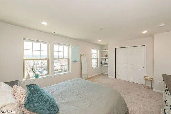 a spacious bedroom with a large bed and a large window
