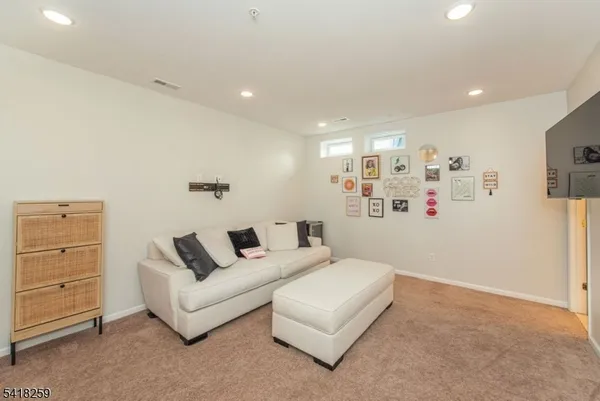 a living room with furniture and a walk in closet
