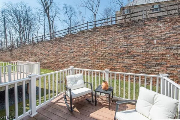 a view of a chair and table on the deck
