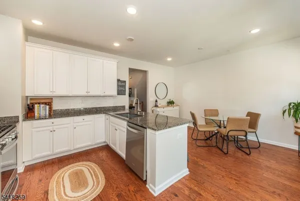a kitchen with a stove sink and cabinets