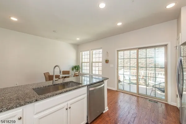 a kitchen with granite countertop a sink and a large window