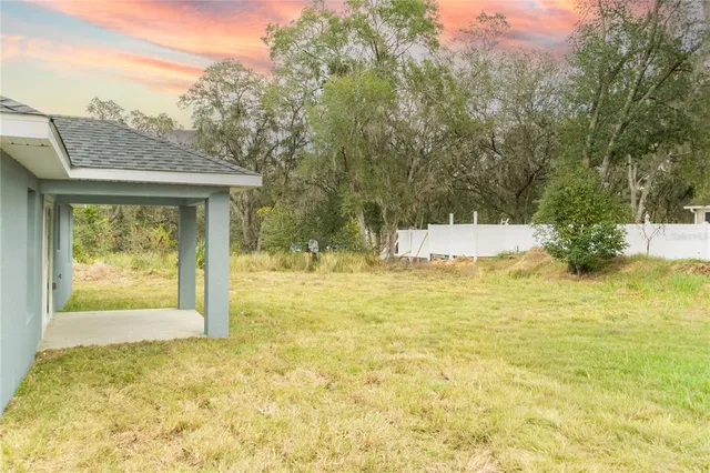 a view of a house with pool and a yard