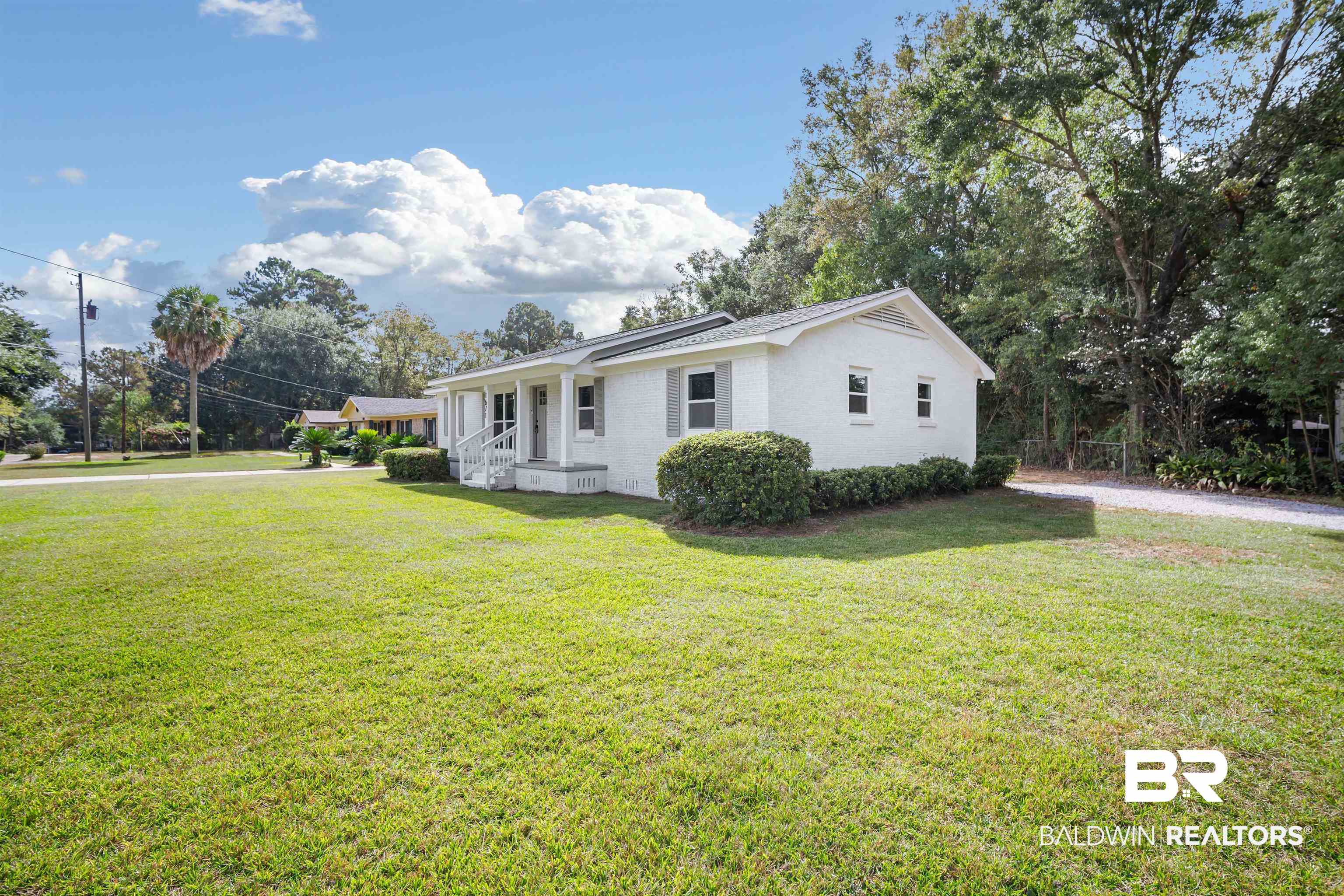1671 Dothan Street Mobile, AL 36618 - Photo 3 of 25 View of home's exterior featuring a lawn