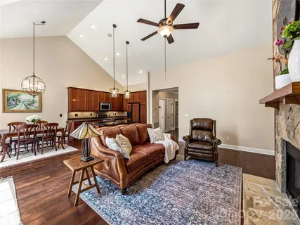 a living room with furniture ceiling fan and a rug