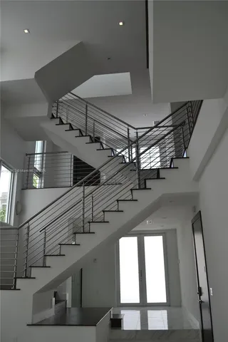 a view of a kitchen with a sink and wooden floor