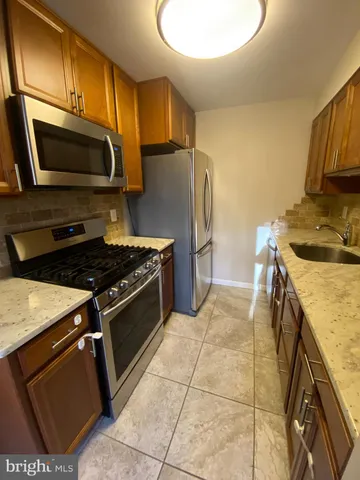 a kitchen with a stove microwave and refrigerator