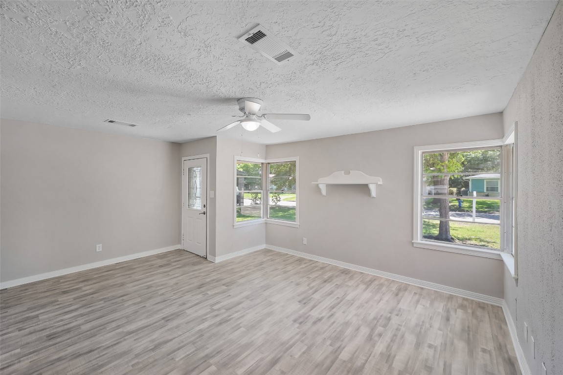 8527 Brower Street Houston, TX 77017 - Photo 4 of 19 an empty room with wooden floor and windows