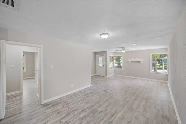 wooden floor in an empty room and a window in a room