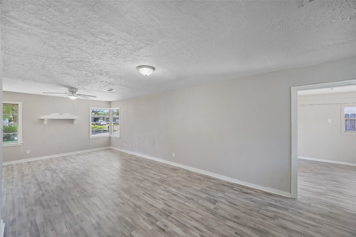8527 Brower Street Houston, TX 77017 - Photo 8 of 19 an empty room with wooden floor and windows