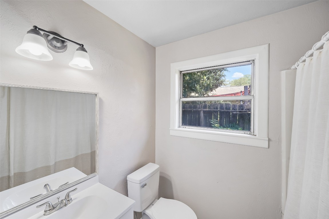 8527 Brower Street Houston, TX 77017 - Photo 9 of 19 a bathroom with a toilet sink and mirror