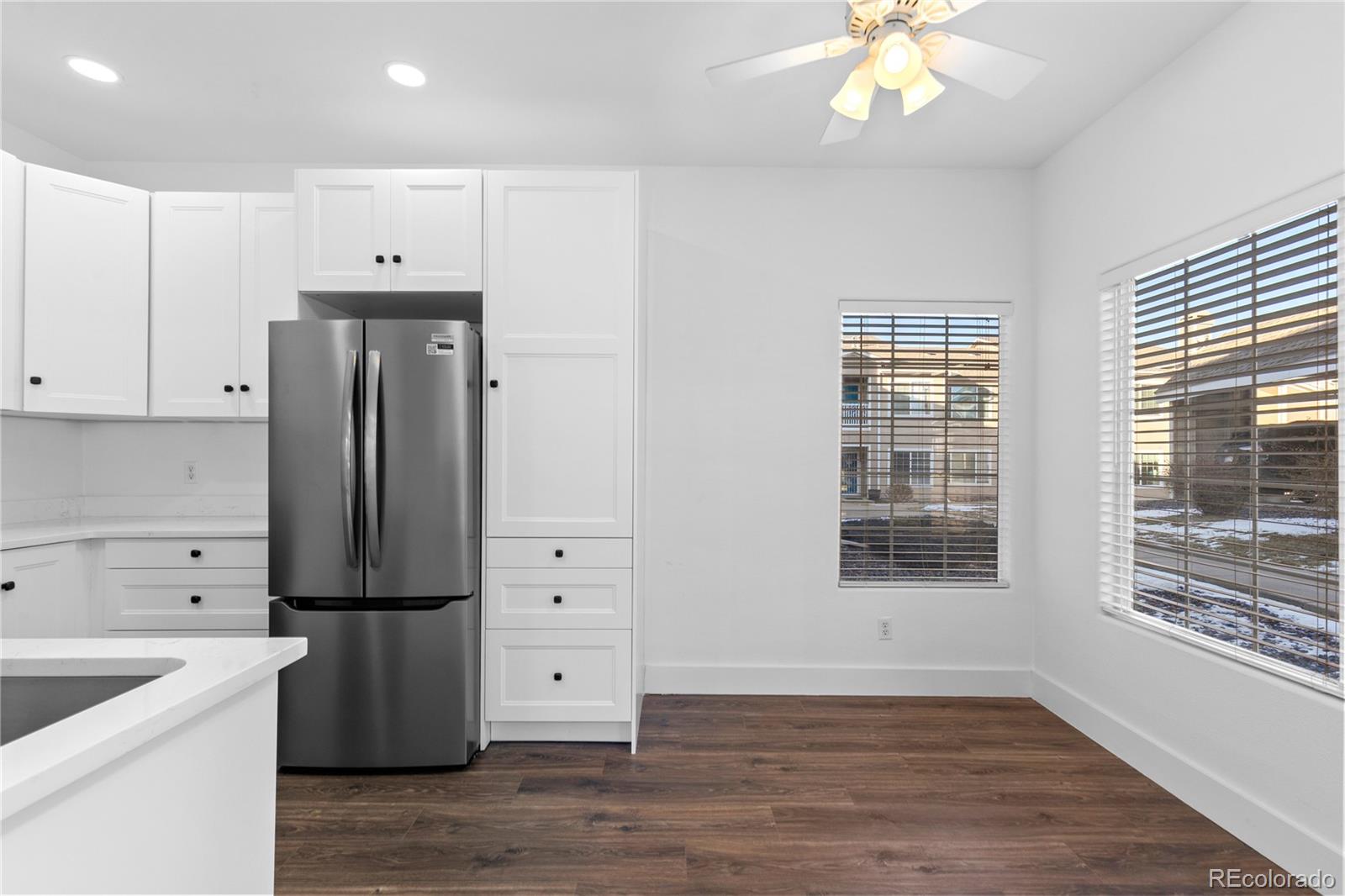 3855 East Canyon Ranch Road, Unit 104 Highlands Ranch, CO 80126 - Photo 11 of 36 an empty room with wooden floor and cabinet
