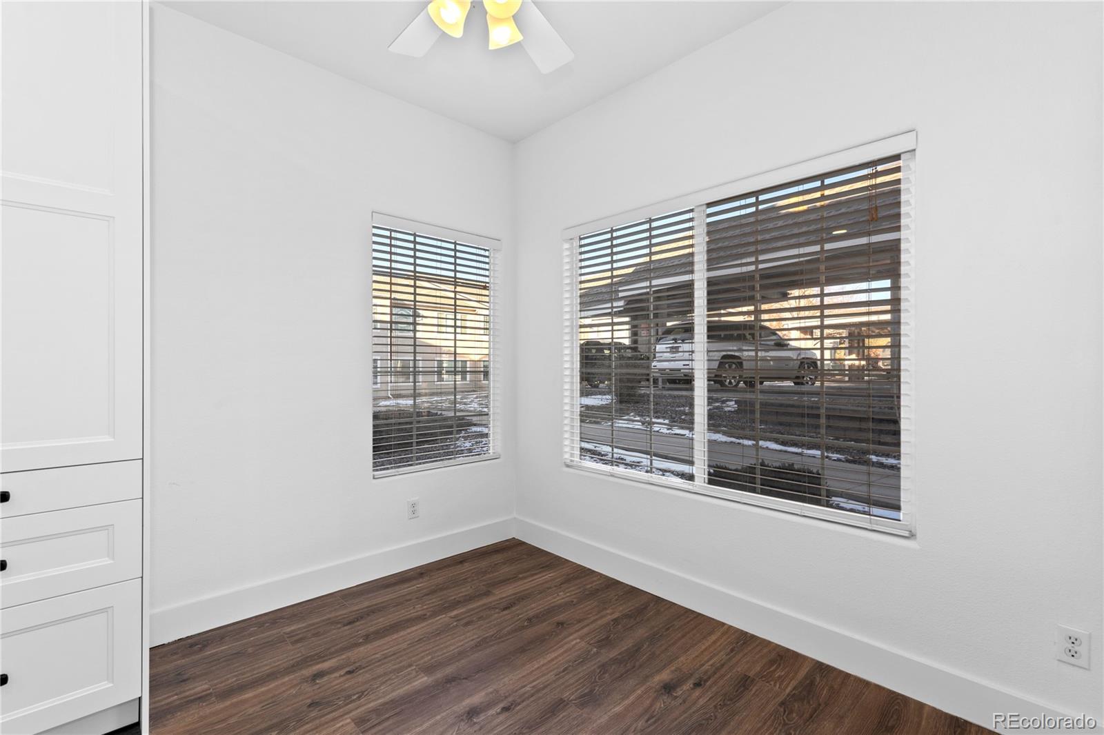 3855 East Canyon Ranch Road, Unit 104 Highlands Ranch, CO 80126 - Photo 12 of 36 a view of an empty room with wooden floor and a window