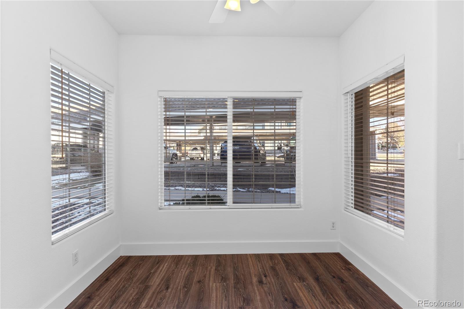 3855 East Canyon Ranch Road, Unit 104 Highlands Ranch, CO 80126 - Photo 14 of 36 a view of wooden floor and windows in a room