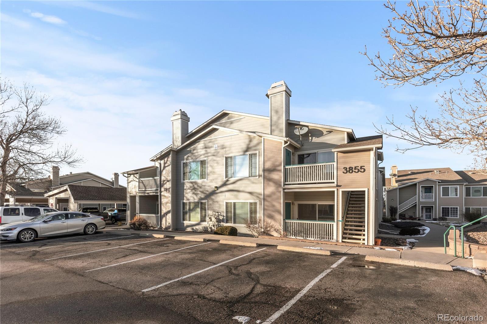 3855 East Canyon Ranch Road, Unit 104 Highlands Ranch, CO 80126 - Photo 33 of 36 a front view of a building with parking space