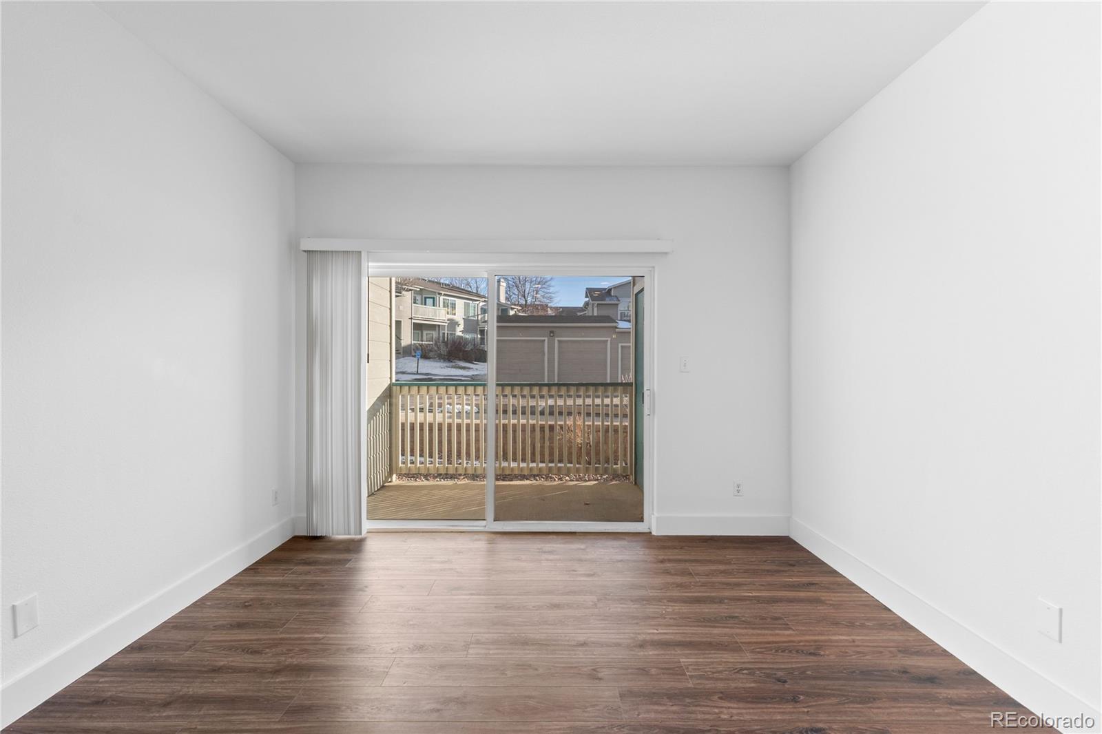 3855 East Canyon Ranch Road, Unit 104 Highlands Ranch, CO 80126 - Photo 4 of 36 wooden floor in an empty room