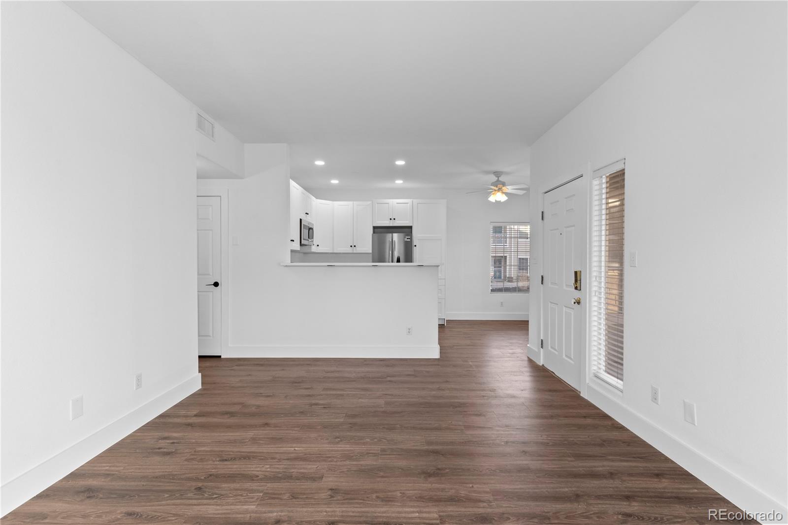 3855 East Canyon Ranch Road, Unit 104 Highlands Ranch, CO 80126 - Photo 6 of 36 a view of kitchen with wooden floor