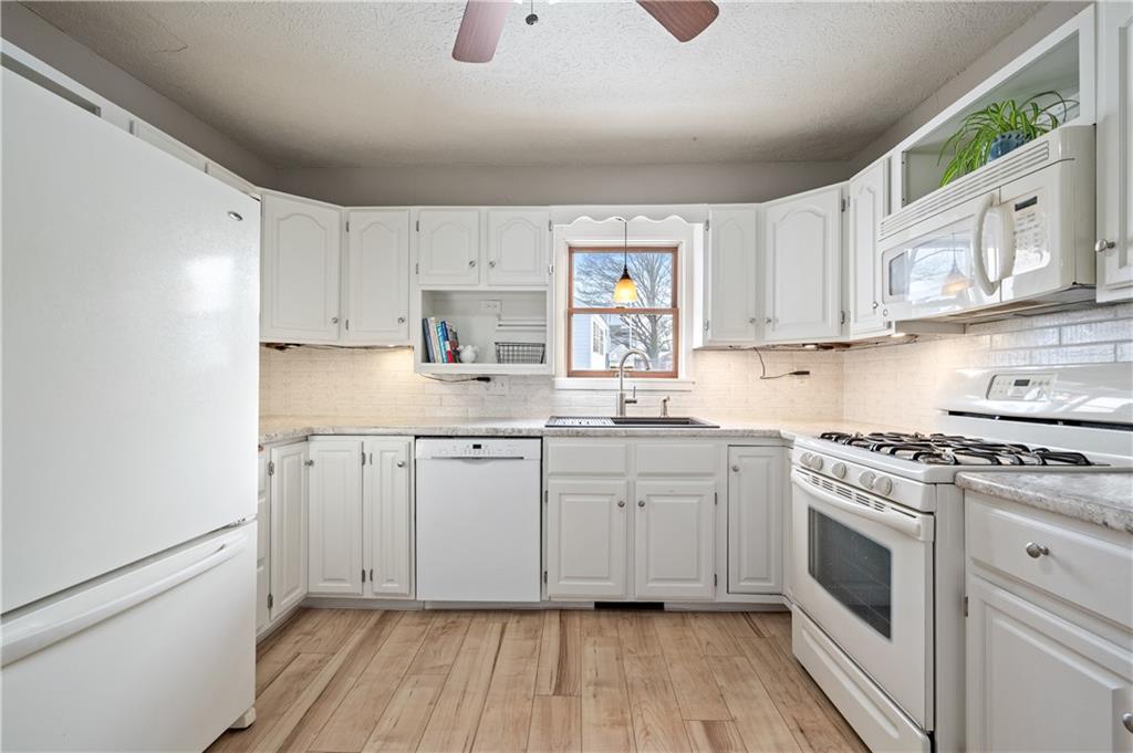 232 Naugle Road Beaver Falls, PA 15010 - Photo 8 of 26 The kitchen is bright and newly updated with a subway tile backsplash, farmhouse sink and upgraded countertops.