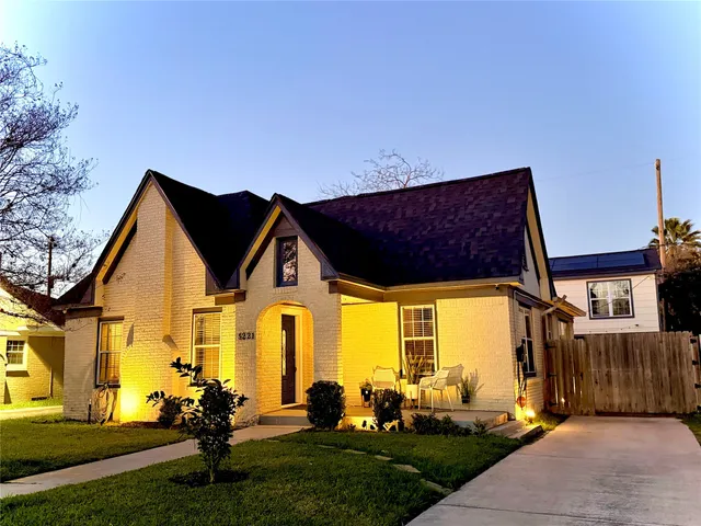 a front view of house with a garden