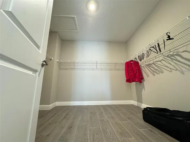a view of a room with wooden floor and cabinet