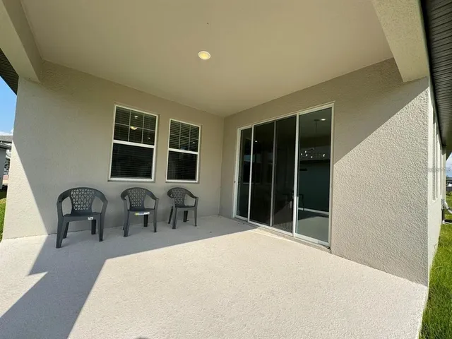 a large bed sitting in a room next to a window