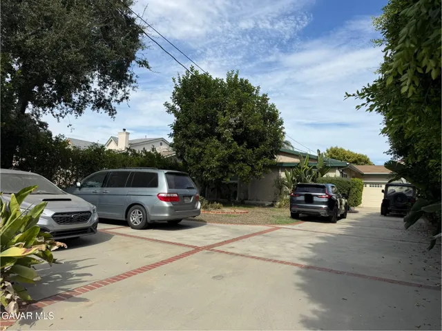 a view of a car parked in front of a house