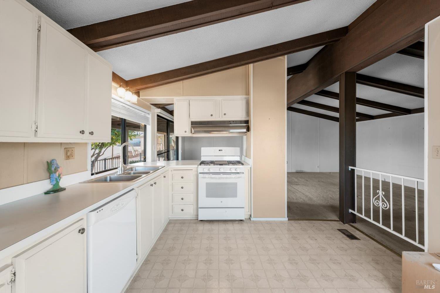 76 Lemon Tree Circle Vacaville, CA 95687 - Photo 14 of 30 a kitchen that has a lot of cabinets in it and wooden floors