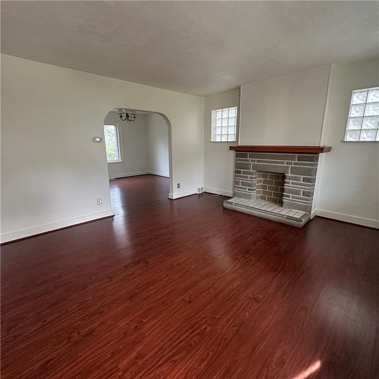 240 Ridgewood Avenue Pittsburgh, PA 15229 - Photo 3 of 14 an empty room with wooden floor mirror and windows