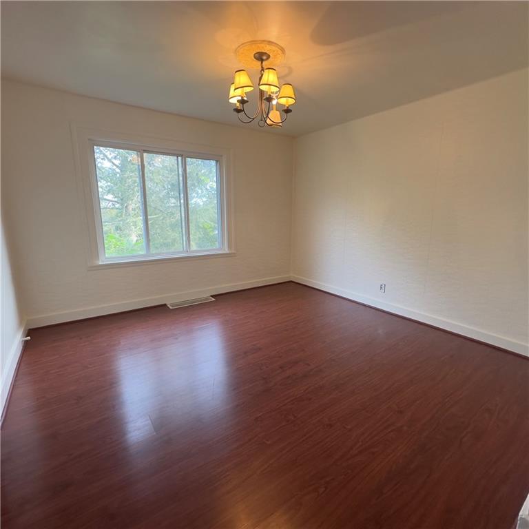 240 Ridgewood Avenue Pittsburgh, PA 15229 - Photo 5 of 14 an empty room with wooden floor and windows