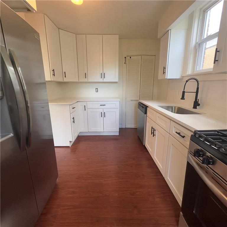 240 Ridgewood Avenue Pittsburgh, PA 15229 - Photo 7 of 14 a kitchen with stainless steel appliances a sink stove refrigerator and cabinets