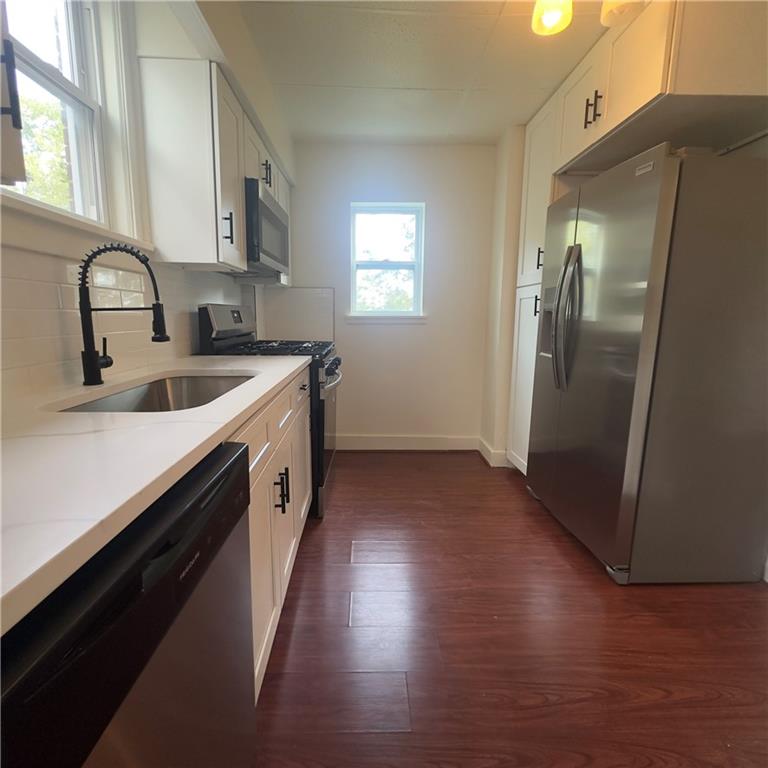 240 Ridgewood Avenue Pittsburgh, PA 15229 - Photo 8 of 14 a kitchen with a sink a refrigerator and wooden floor