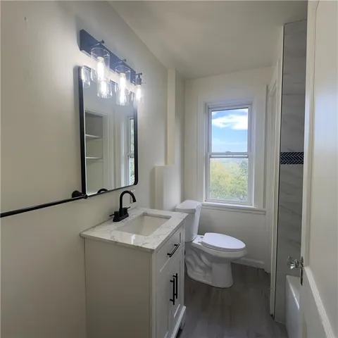 a bathroom with a double vanity sink toilet and a mirror