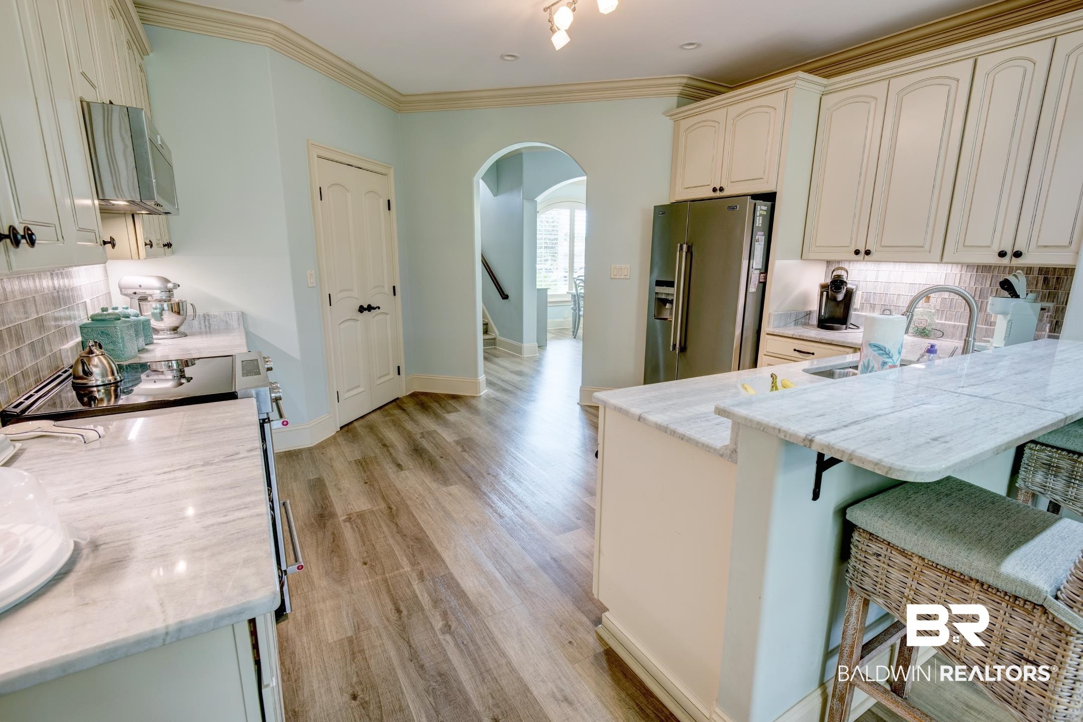 9357 Lakeview Drive Foley, AL 36535 - Photo 33 of 68 Kitchen featuring light-toned cabinetry, stainless steel appliances, and wood-finish flooring